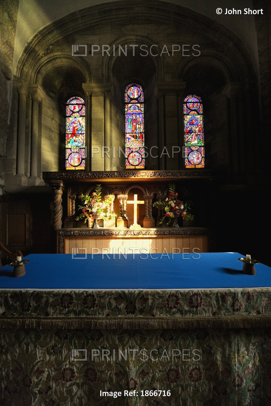 Cross Illuminated At The Altar Of A Church