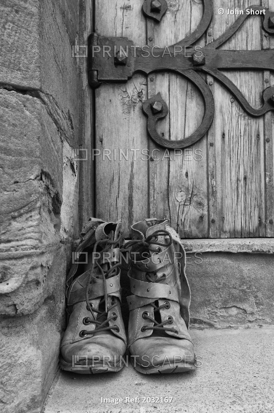A Pair Of Worn Boots Outside A Door; Northumberland, England
