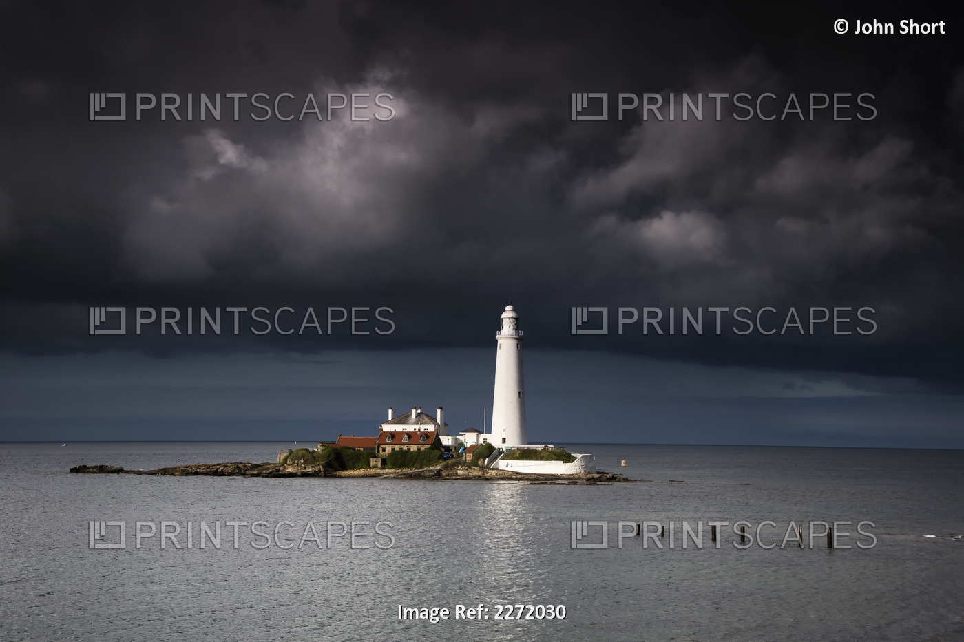 White Lighthouse Illuminated By Sunlight Under Dark Storm Clouds; St. Mary's ...