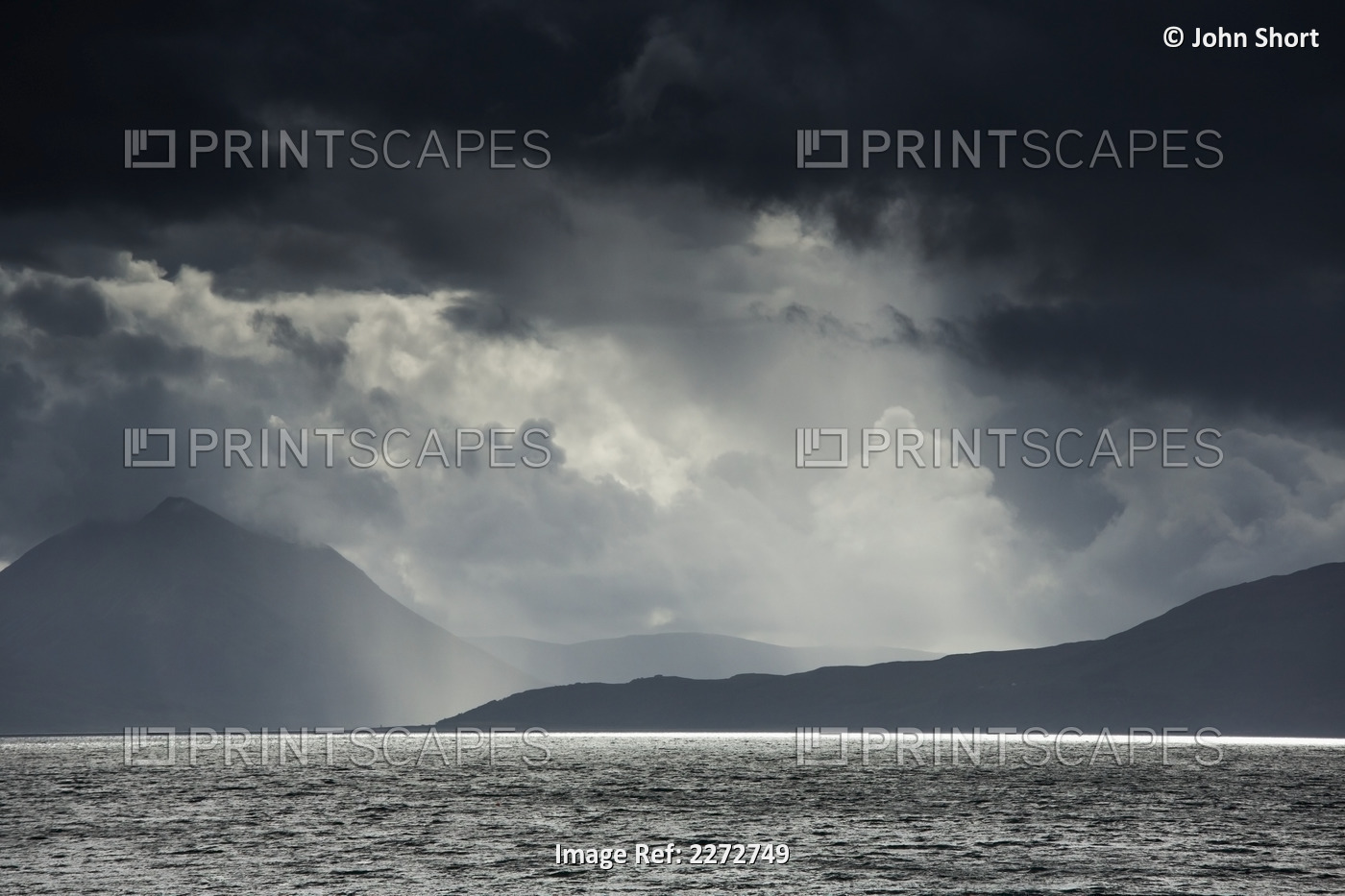 Sunlight shining through dark storm clouds;Applecross peninsula highlands ...