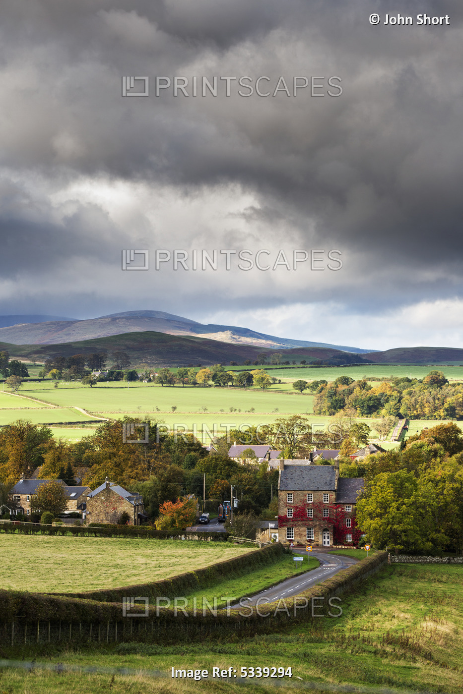 Grass Fields And Autumn Coloured Trees Under Storm Clouds; Wittingham, ...