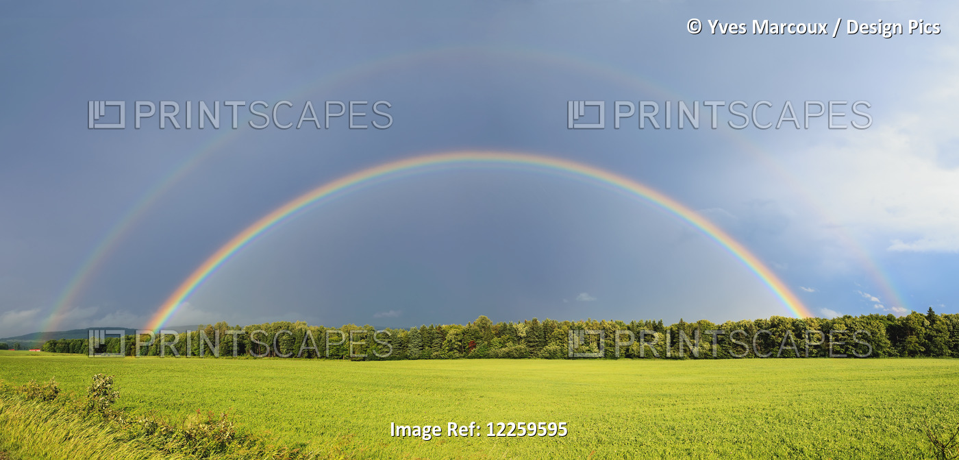 Double Rainbow Over Trees And Lush Green Field; Quebec, Canada