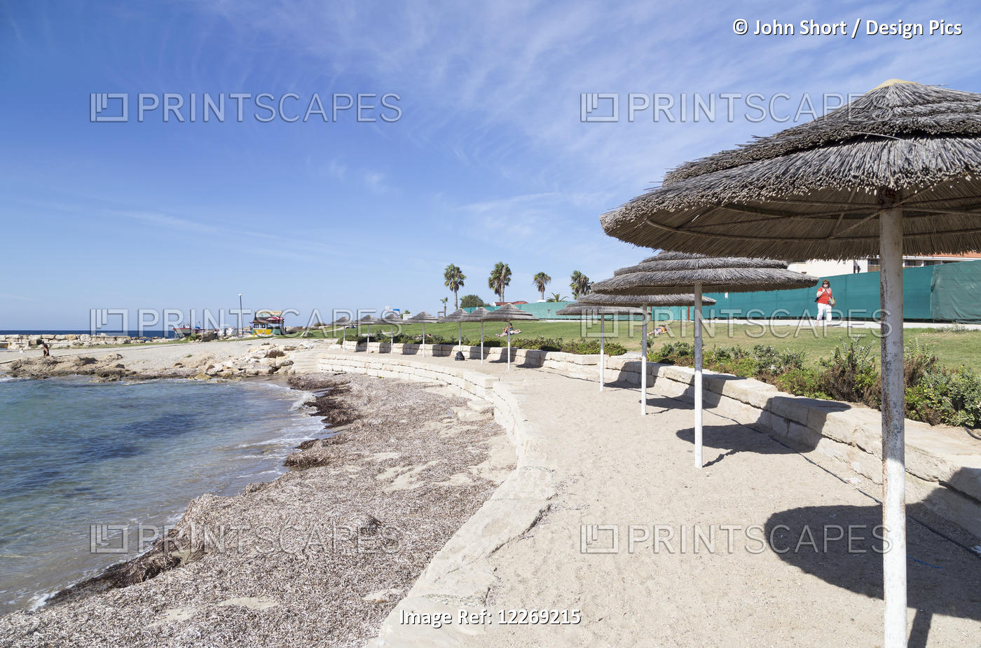 White Sand Beach With Umbrellas Lining The Coast; Yeroskipou, Paphos, Cyprus