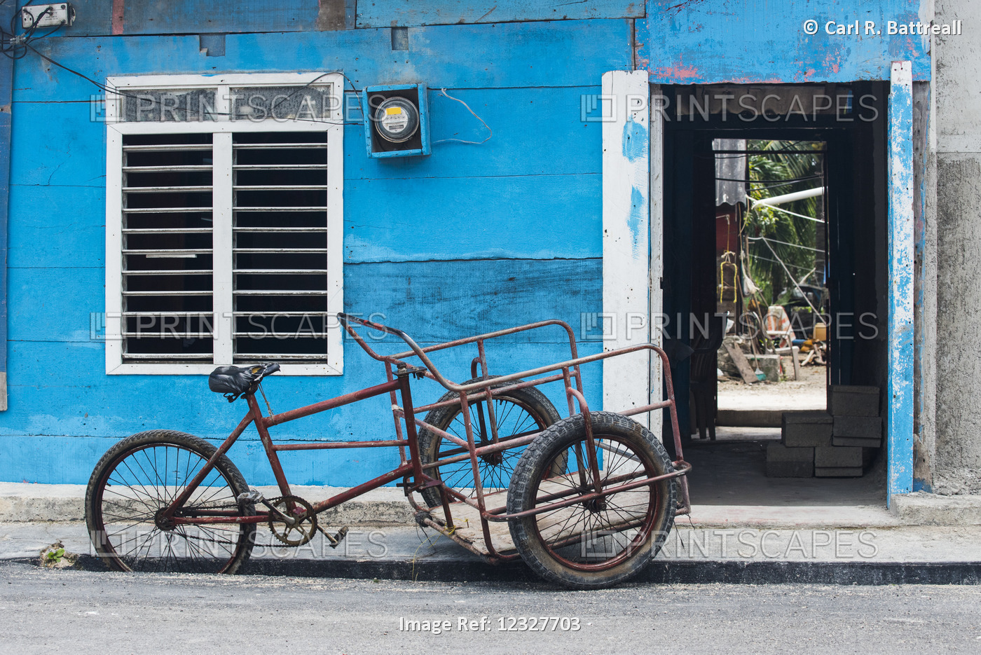 Three Wheeled Bike Parked On The Street Beside A Blue Building; Yucatan ...