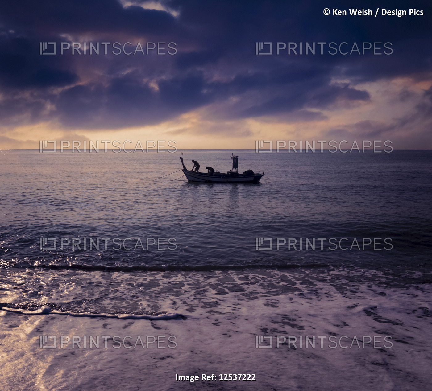 Fishing boat viewed from the shore of Torremolinos Beach at sunrise; Costa del ...