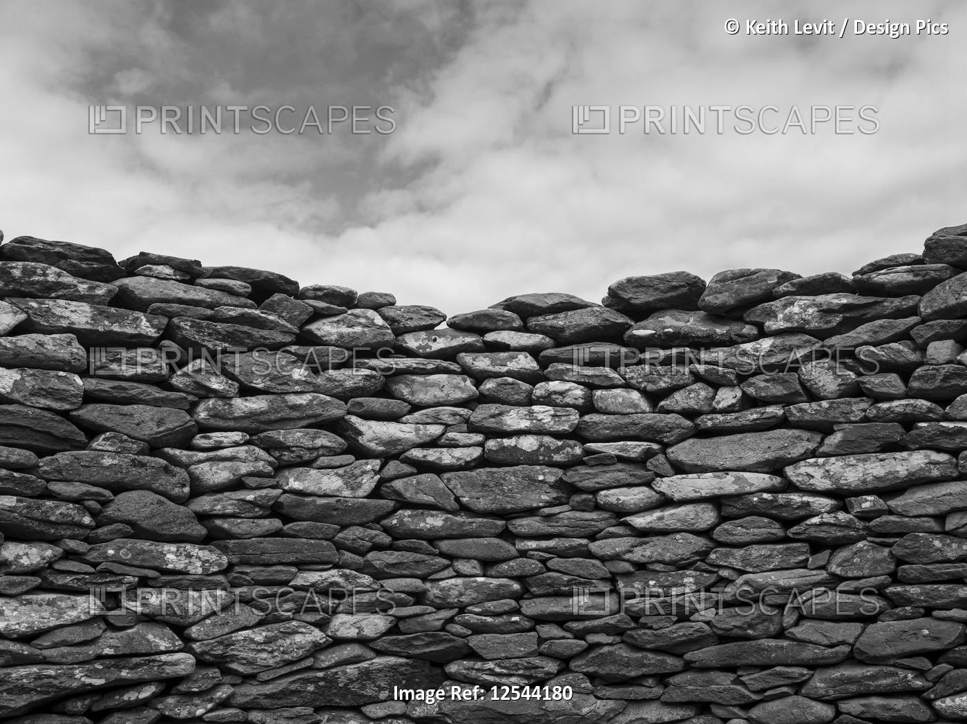 Close-up of a stone wall and clouds in the sky; Ballyferriter, County Kerry, ...
