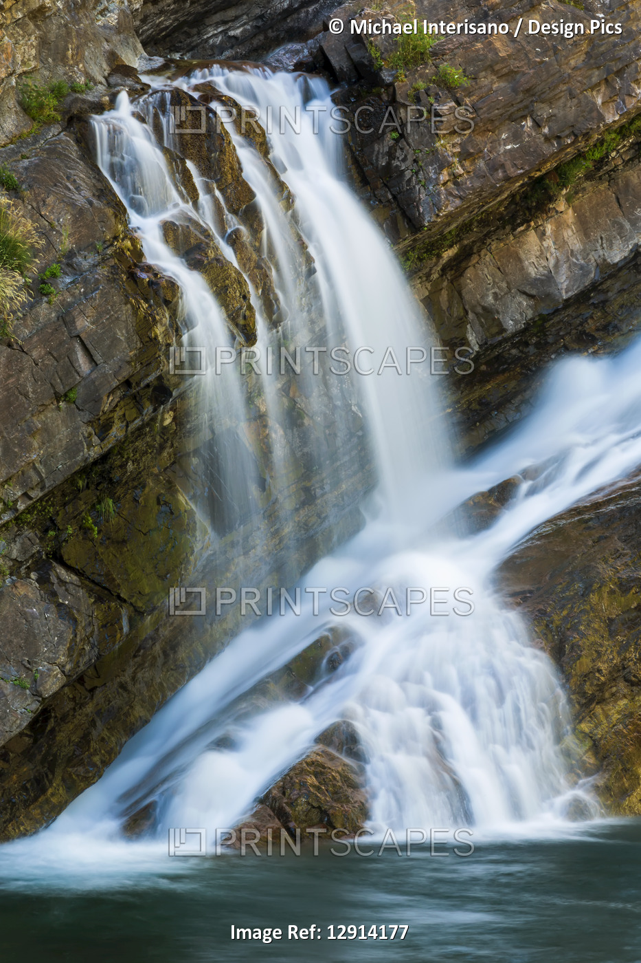 Waterfalls on angled rocky cliff, Waterton Lakes National Park; Waterton, ...