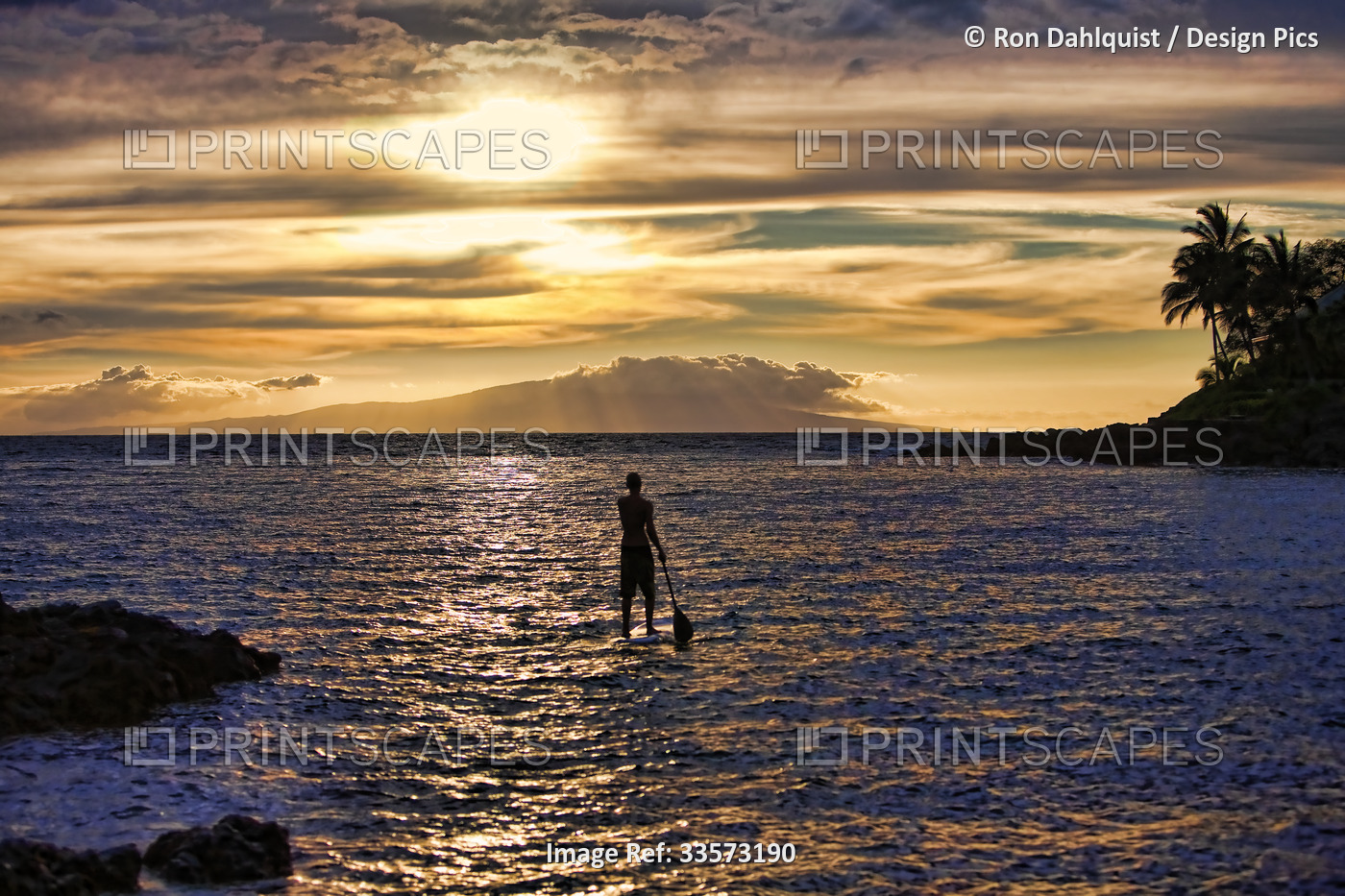 View taken from behind of a stand-up paddle boarder at sunset off Palau'ea ...