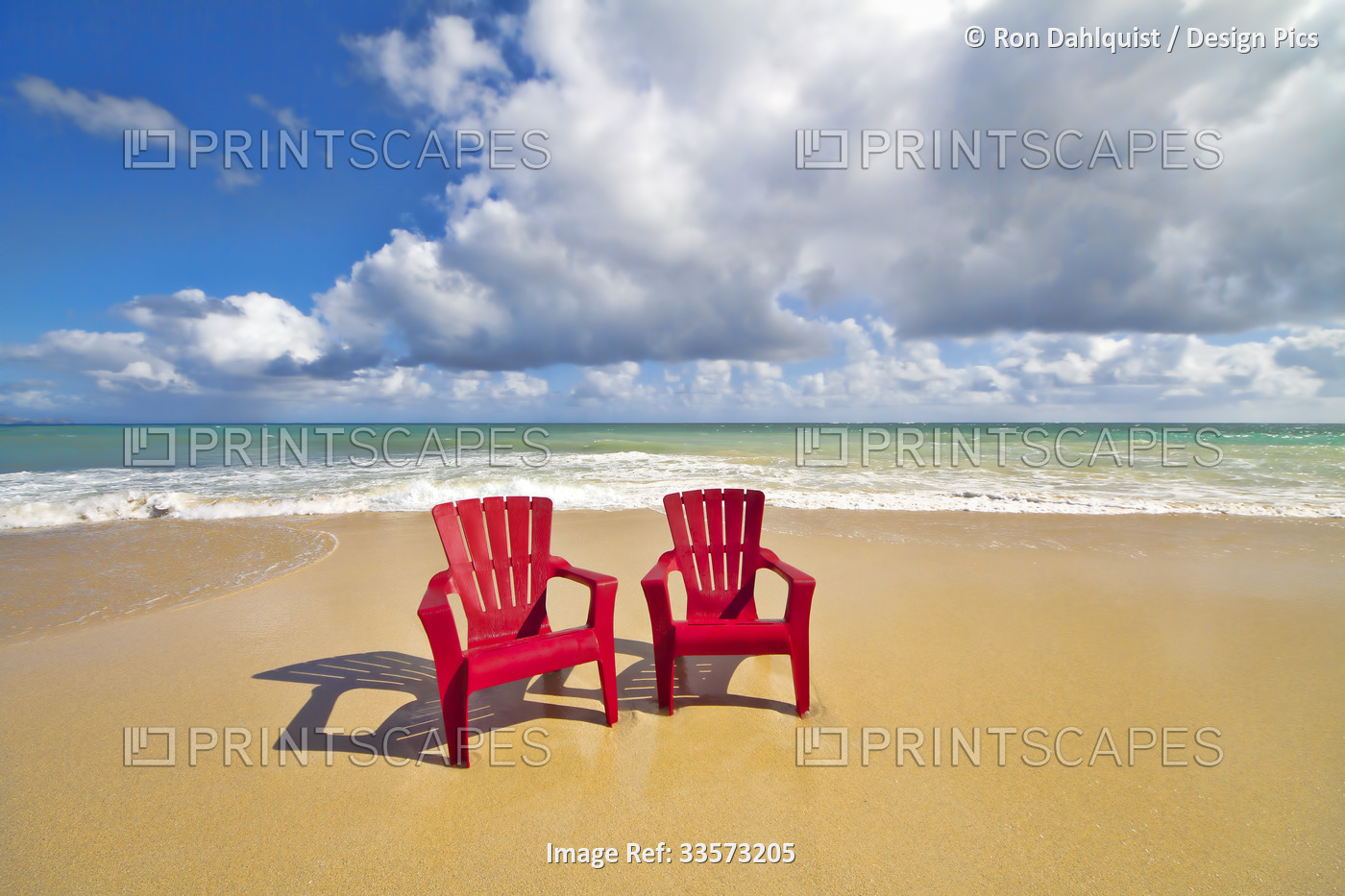 Red, beach chairs beckon on the sandy beach at Baldwin Beach on the north shore ...